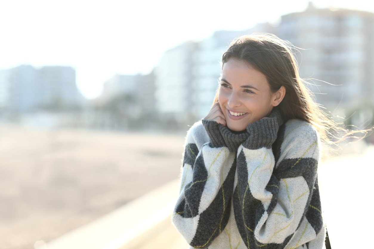 Woman enjoying sunshine winter jumper