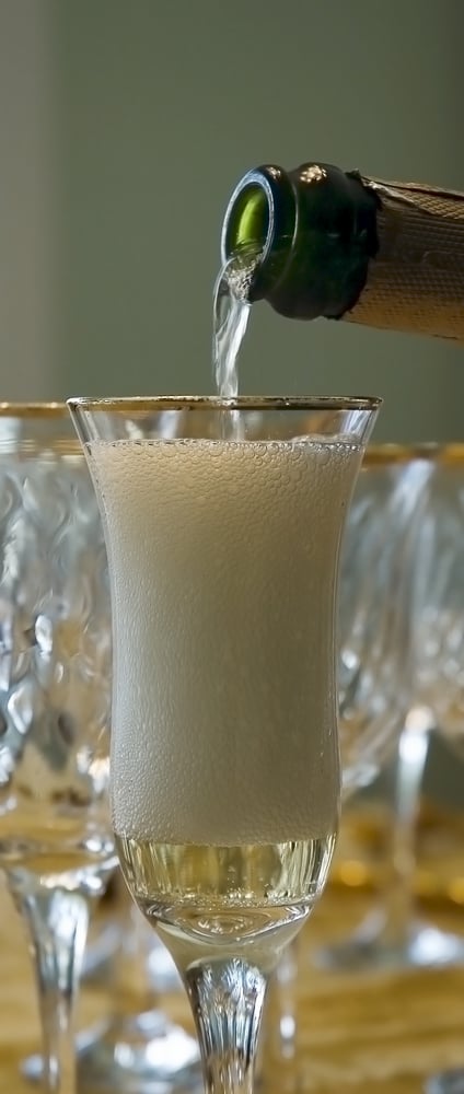 Champagne being poured into a champagne glass