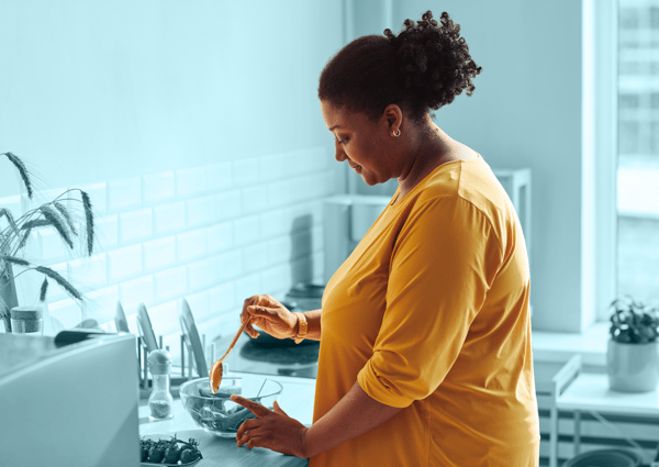 black-woman-cooking-in-cozy-kitchen-2023-11-27-05-35-20-utc 1