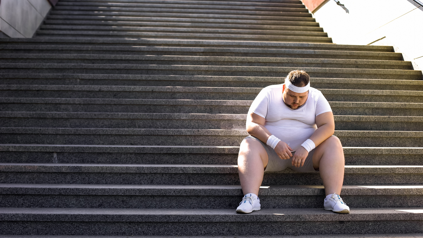 Man out of breath on stairs.